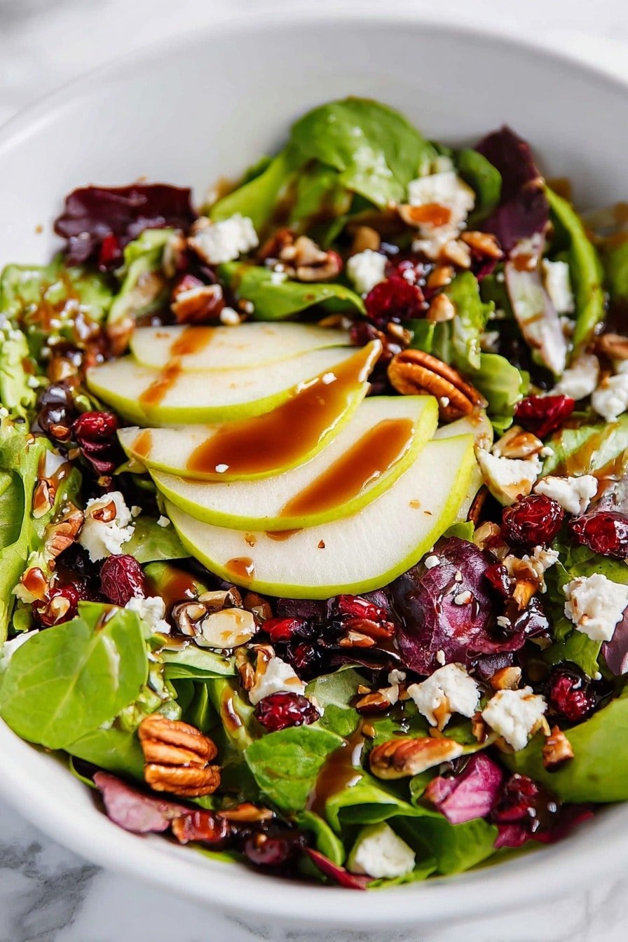 A fresh salad is shown in a white bowl placed on a white marbled surface. The salad has three main layers: the base layer is mixed green leaves with different shades of green and purple, the second layer has thin slices of green pear arranged partly on top of the greens, and the third layer is made of scattered small pieces of white cheese, brown pecan nuts, and small dark red dried cranberries. On top, a shiny dark brown dressing is drizzled unevenly over the ingredients, giving them a glossy look. photo taken with an iphone --ar 2:3 --v 7