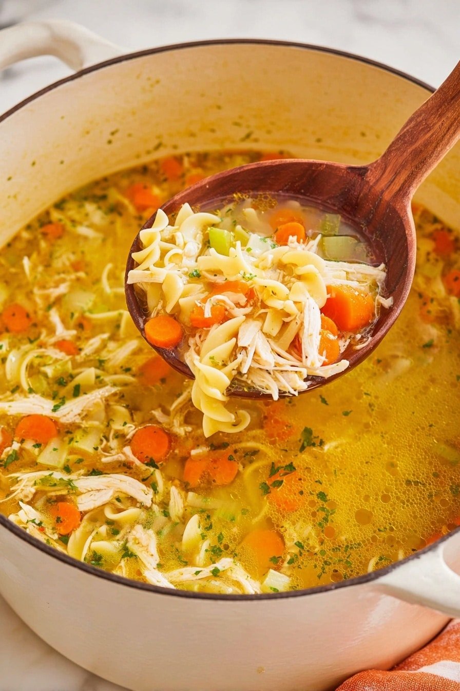 A close-up view of a large white pot filled with a golden-yellow clear soup containing three main layers: at the bottom, small orange carrot slices and green celery pieces scattered throughout; in the middle, light yellow spiral pasta twists mixed with shredded white chicken pieces; and at the top, a wooden spoon lifting a mix of all these ingredients, highlighting the bright, fresh colors and chunky textures of the carrots, celery, pasta, and chicken, against a white marbled surface background. photo taken with an iphone --ar 2:3 --v 7