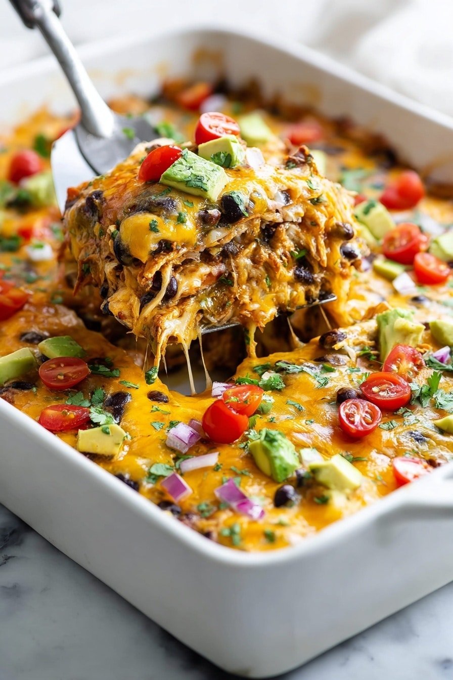 A white baking dish filled with a cheesy layered casserole is shown on a white marbled surface. The dish has several colorful layers: melted orange-yellow cheese covers shredded chicken mixed with black beans, small pieces of red and green bell peppers, diced red onions, and small chunks of avocado. The top is sprinkled with chopped cilantro and bright red cherry tomatoes, creating a fresh, colorful contrast. A metal spatula is lifting a portion from the dish, showing a thick and cheesy texture with visible layers of ingredients. The scene is bright and appealing, emphasizing the rich mix of colors and textures in the casserole. photo taken with an iphone --ar 2:3 --v 7
