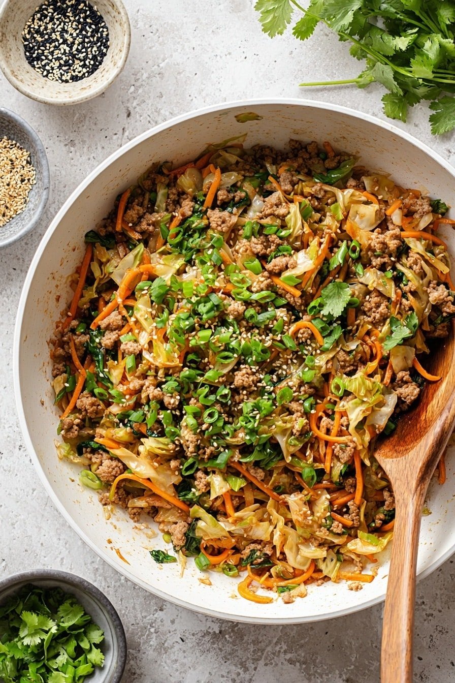 A large white pan filled with a colorful cooked mixture of light brown minced meat, thin orange carrot strips, and soft light tan cabbage pieces. The dish is topped with bright green chopped scallions and fresh green cilantro leaves scattered on top. A wooden spoon rests inside the pan on the right side. Around the pan are small round bowls, one with black and white sesame seeds and another with fresh green cilantro leaves, all placed on a white marbled surface. photo taken with an iphone --ar 2:3 --v 7