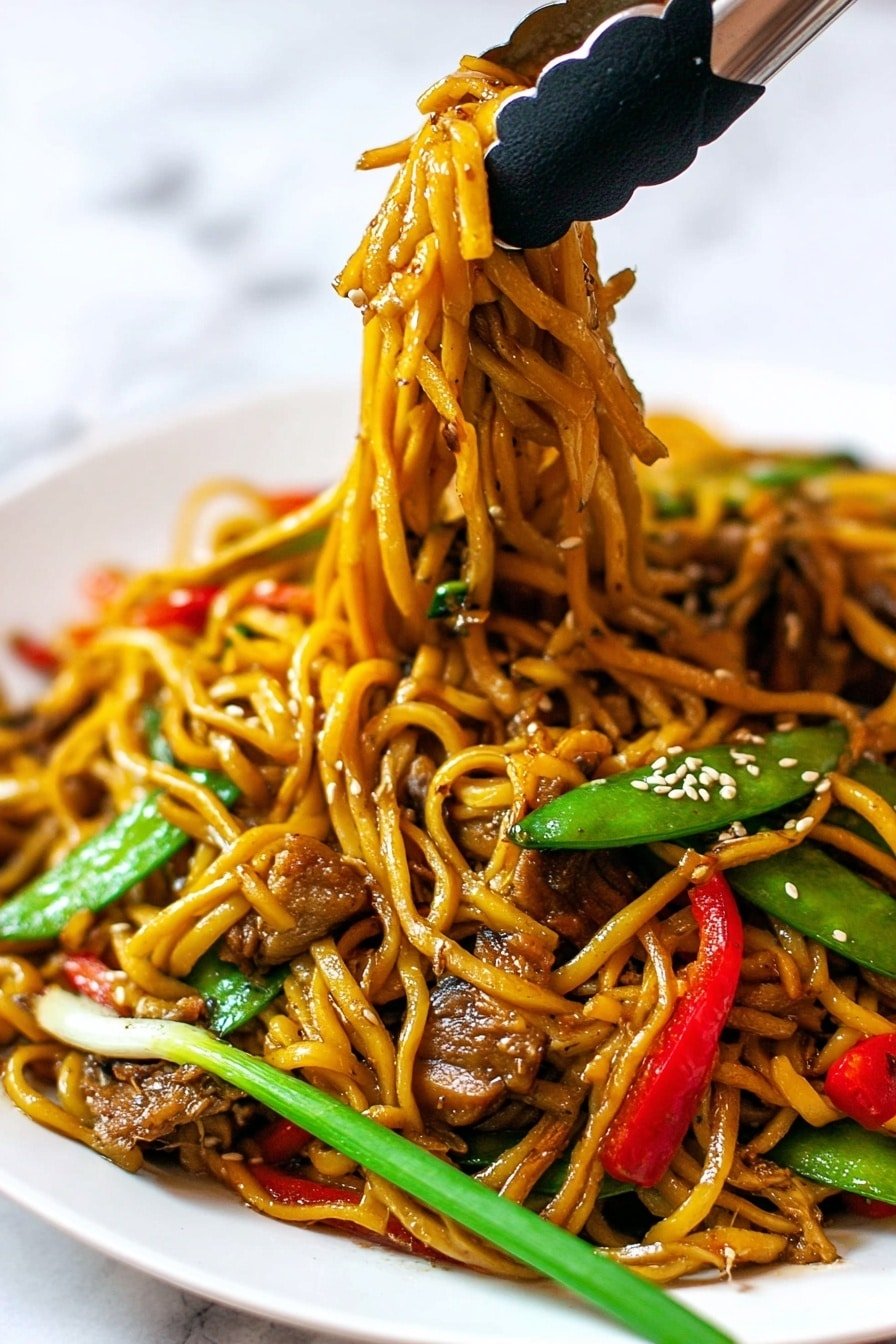 The image shows a close-up of a white plate filled with stir-fried noodles. The dish has thick, golden-brown noodles mixed with bright green snap peas, thin red bell pepper strips, small pieces of cooked brown meat, and slices of light brown mushrooms. There are also scattered sesame seeds on top. A pair of tongs with black silicone tips is lifting a bundle of noodles and vegetables, showing the shiny, slightly oily texture of the noodles. A single green onion stalk lies across the noodles on the plate. The background has a white marbled surface. photo taken with an iphone --ar 2:3 --v 7