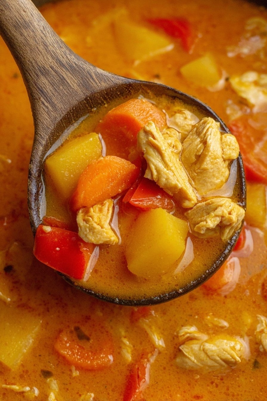 A close-up of a wooden spoon lifting a thick orange soup filled with three main layers: chunks of tender light yellow chicken pieces, slices of bright orange carrots, and soft yellow potato cubes, all mixed in a smooth orange broth with visible red bell pepper slices scattered around. The background is a white marbled texture showing more soup with similar ingredients floating. The soup looks creamy and hearty, with the wooden spoon centered in the image. Photo taken with an iphone --ar 2:3 --v 7