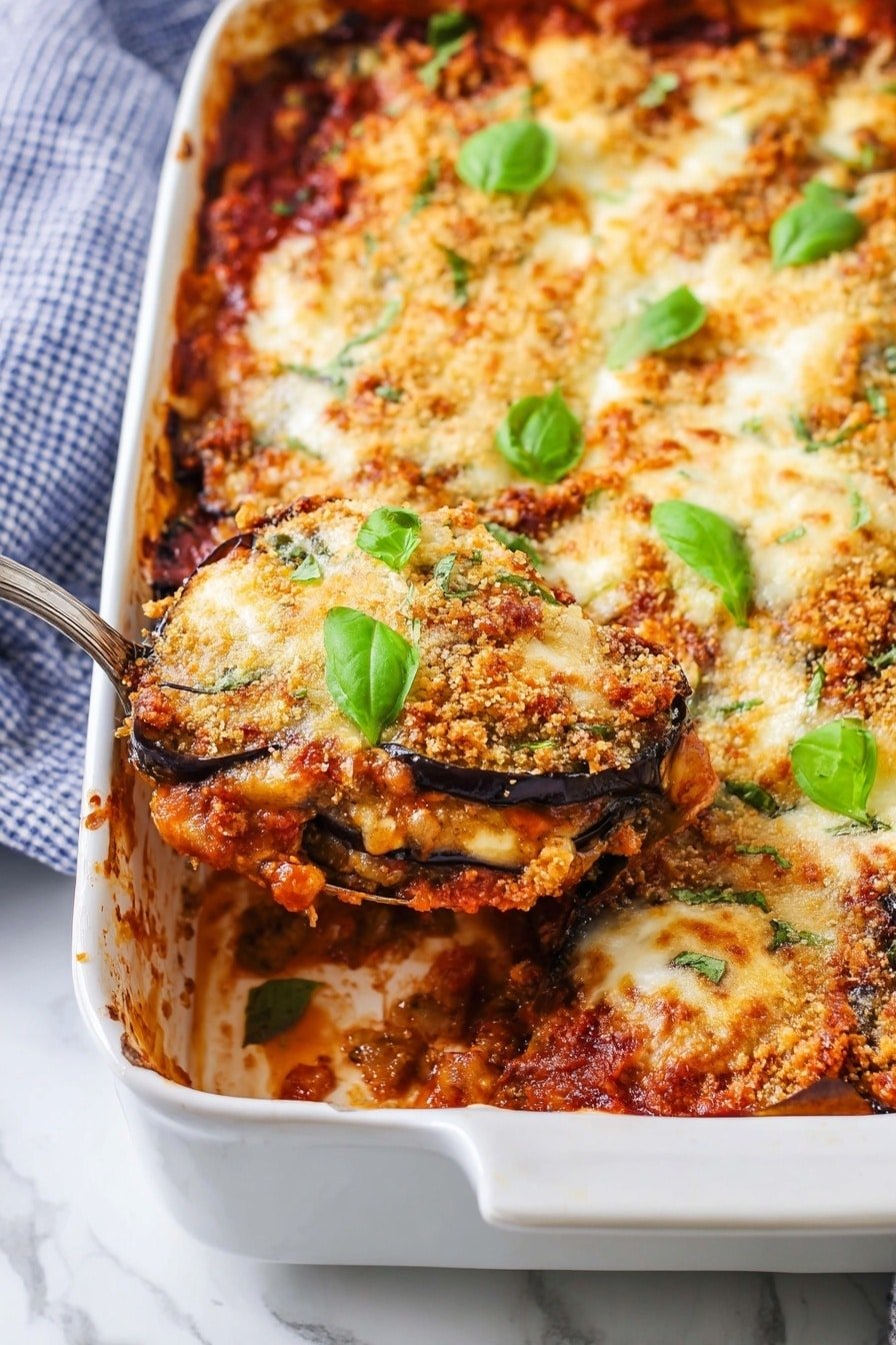 The dish is a baked casserole in a white rectangular dish, showing layers of rich red tomato sauce with chunks underneath, covered by slices of dark purple eggplant. On top, there is a thick layer of melted creamy cheese with browned crispy breadcrumbs that create a golden textured crust. Fresh green basil leaves are scattered on the surface, adding color contrast. A shiny metal spoon is lifting a portion from the right side, revealing the dense layered inside with sauce and eggplant. The background is a white marbled surface with a blue and white checkered cloth partially visible. Photo taken with an iphone --ar 2:3 --v 7