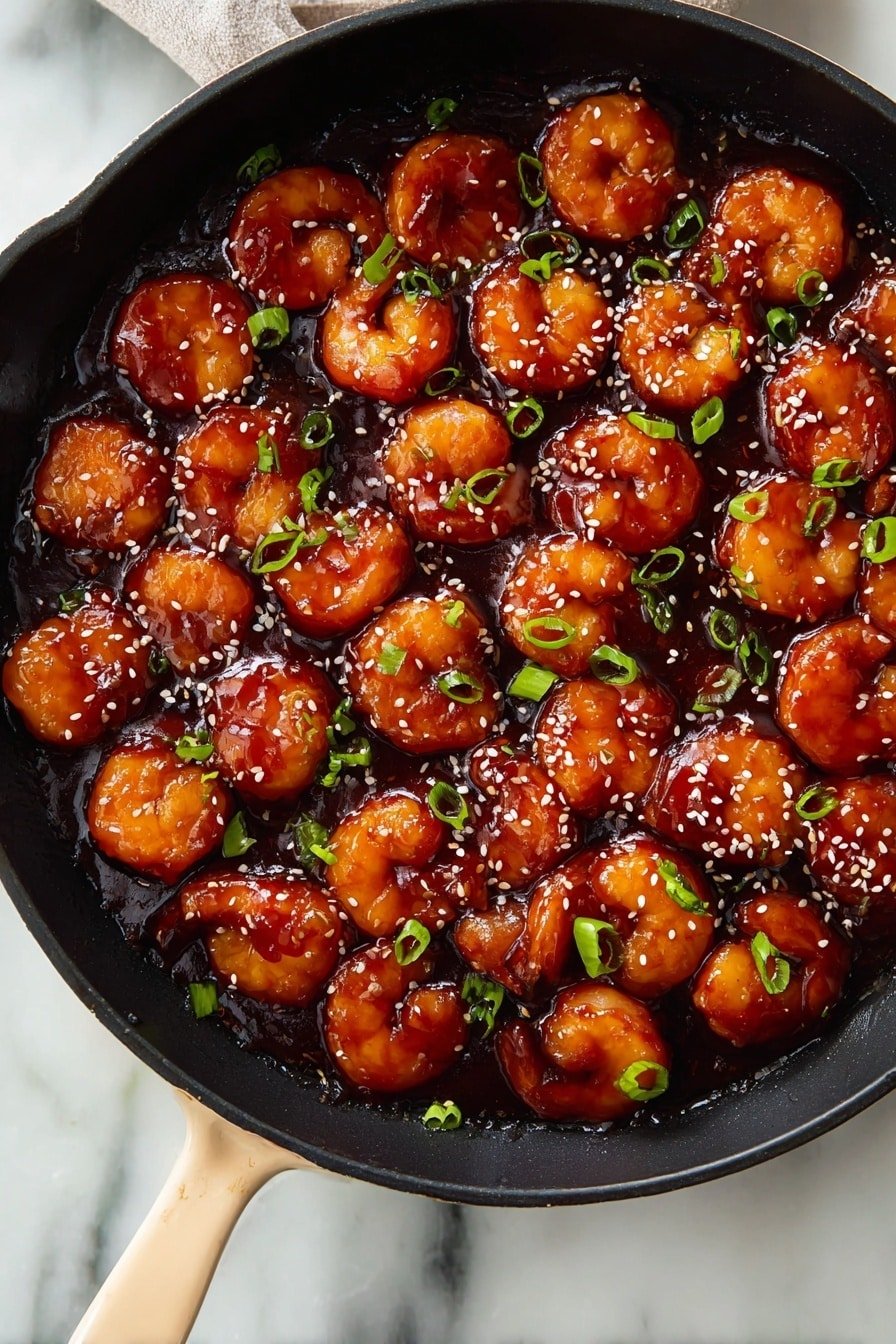 A black pan filled with around 30 golden-brown, round fried pieces covered in a thick, shiny dark reddish-brown sauce. The pieces are evenly coated and spread across the pan. Small green onion slices and white sesame seeds are sprinkled on top, adding specks of green and white to the rich sauce. The pan handle is a soft beige color, resting on a white marbled surface. photo taken with an iphone --ar 2:3 --v 7