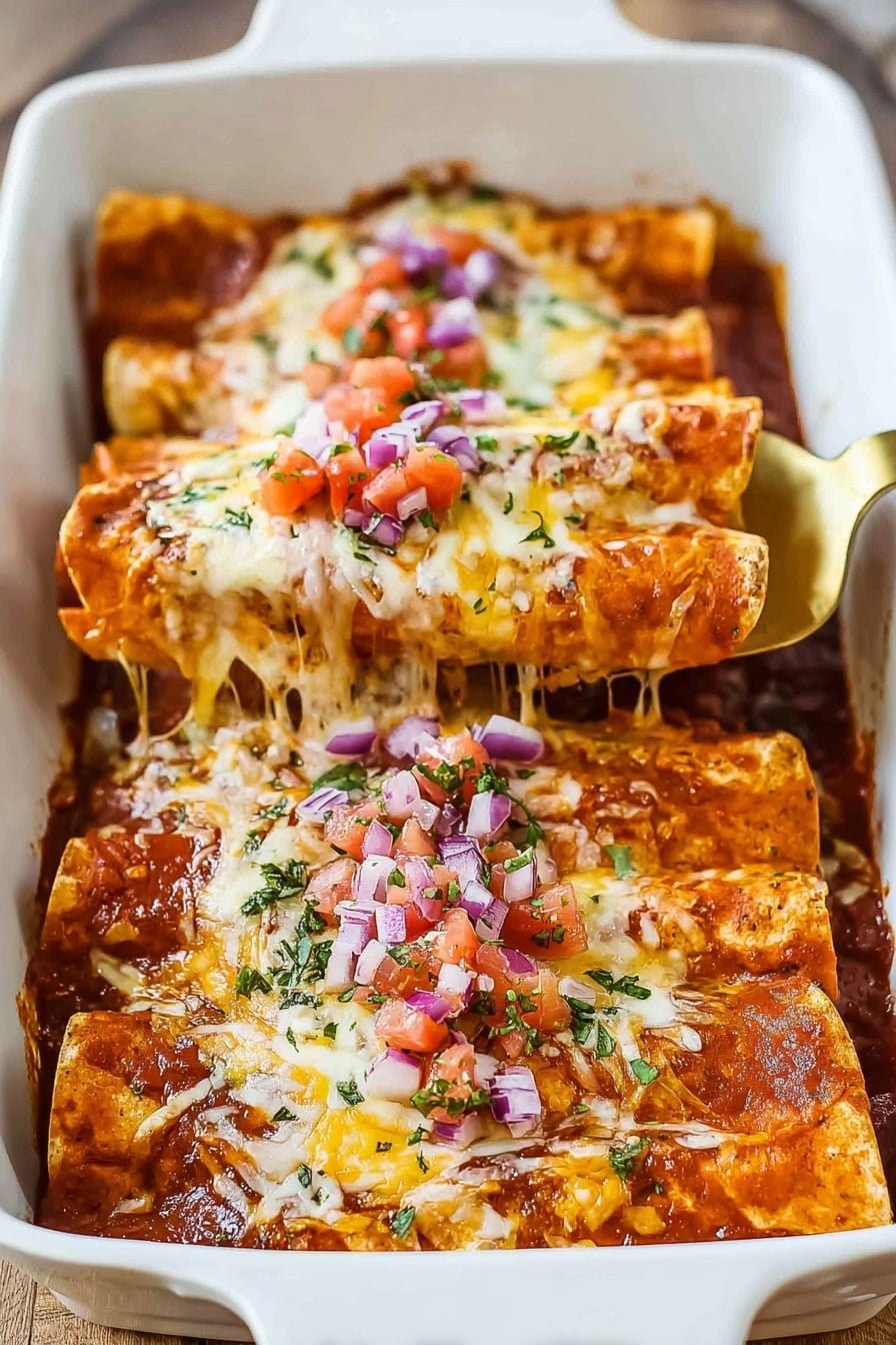 This image shows a white rectangular baking dish with three enchiladas stacked side by side. Each enchilada has a soft, light brown tortilla base covered with a thick layer of red sauce. They are topped with melted creamy white cheese that stretches as one enchilada is lifted by a woman's hand holding a golden spatula. On top of the cheese, there are small diced pieces of bright red tomatoes, purple onions, and green herbs sprinkled evenly. The enchiladas look shiny and moist, resting on a warm wood texture surface. Photo taken with an iphone --ar 2:3 --v 7