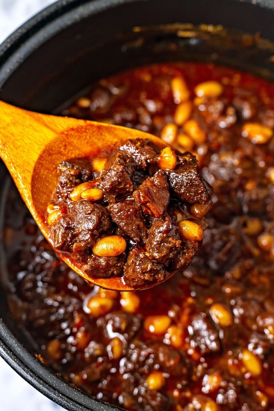 A close-up image showing a wooden spoon lifting thick stew from a black pot. The stew has dark brown, irregular chunks of meat mixed with light yellow beans, all covered in shiny, rich, reddish-brown sauce. The stew fills the pot, with a glossy surface that shows small bubbles and bits of vegetables. The wooden spoon is light orange, contrasting with the stew's dark colors. The background shows the black interior of the pot against a white marbled texture. photo taken with an iphone --ar 2:3 --v 7
