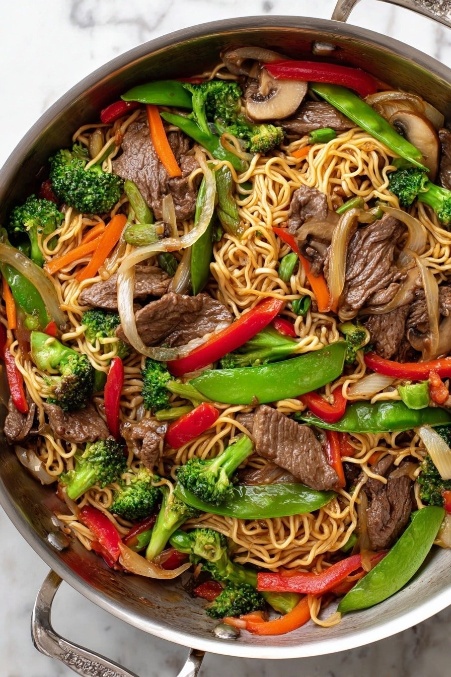 The image shows a metal pan filled with a colorful stir-fry dish. The bottom layer has light brown cooked noodles mixed with bright green broccoli florets and green sugar snap peas. Scattered throughout are thin, dark brown slices of cooked beef. Orange carrot sticks, translucent white onion pieces, red bell pepper chunks, and brown mushroom slices add more colors and textures. The vegetables and beef are evenly spread over the noodles, creating a vibrant and fresh look on a white marbled surface. Photo taken with an iphone --ar 2:3 --v 7