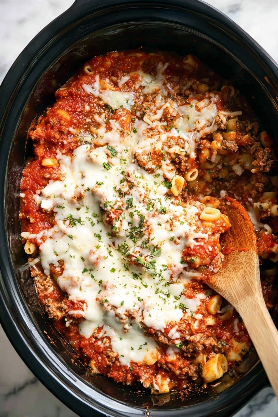 The dish is served in a black slow cooker pot and shows a layered mix of cooked pasta, ground meat, red tomato sauce, and melted white cheese spread unevenly on top. The red sauce has a thick, chunky texture and forms the base and some parts of the top. The melted cheese covers most of the top in irregular patches, with some areas showing the sauce and pasta underneath. Small green herb pieces are sprinkled over the cheese, adding contrast. A wooden spoon is partially submerged on the right side, mixing some of the layers. The background has a white marbled texture photo taken with an iphone --ar 2:3 --v 7
