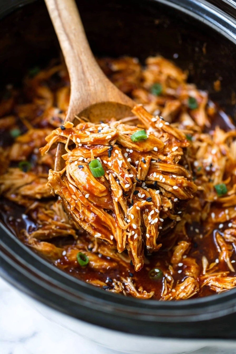 This image shows a close-up of shredded chicken layered with brown sauce and topped with small green onion pieces and white and black sesame seeds. The chicken looks tender with a mix of light and dark golden brown colors, soaking in a shiny, thick reddish-brown sauce. The food fills an ornate white bowl, and a wooden spoon is lifting the layered chicken. The background is a white marbled texture. photo taken with an iphone --ar 2:3 --v 7