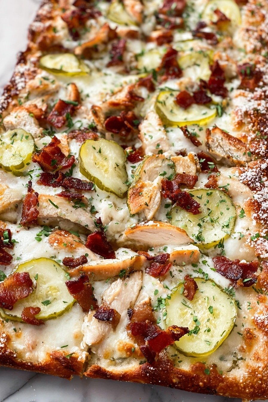 A close-up view of a rectangular pizza shows a golden-brown crust dusted with white cheese. The pizza is covered in thin slices of light green pickles spread evenly, with pieces of light brown cooked chicken scattered on top. Dark reddish-brown crispy bacon bits are sprinkled all over, along with small green herbs adding pops of color. The pizza rests on a white marbled surface. photo taken with an iphone --ar 2:3 --v 7