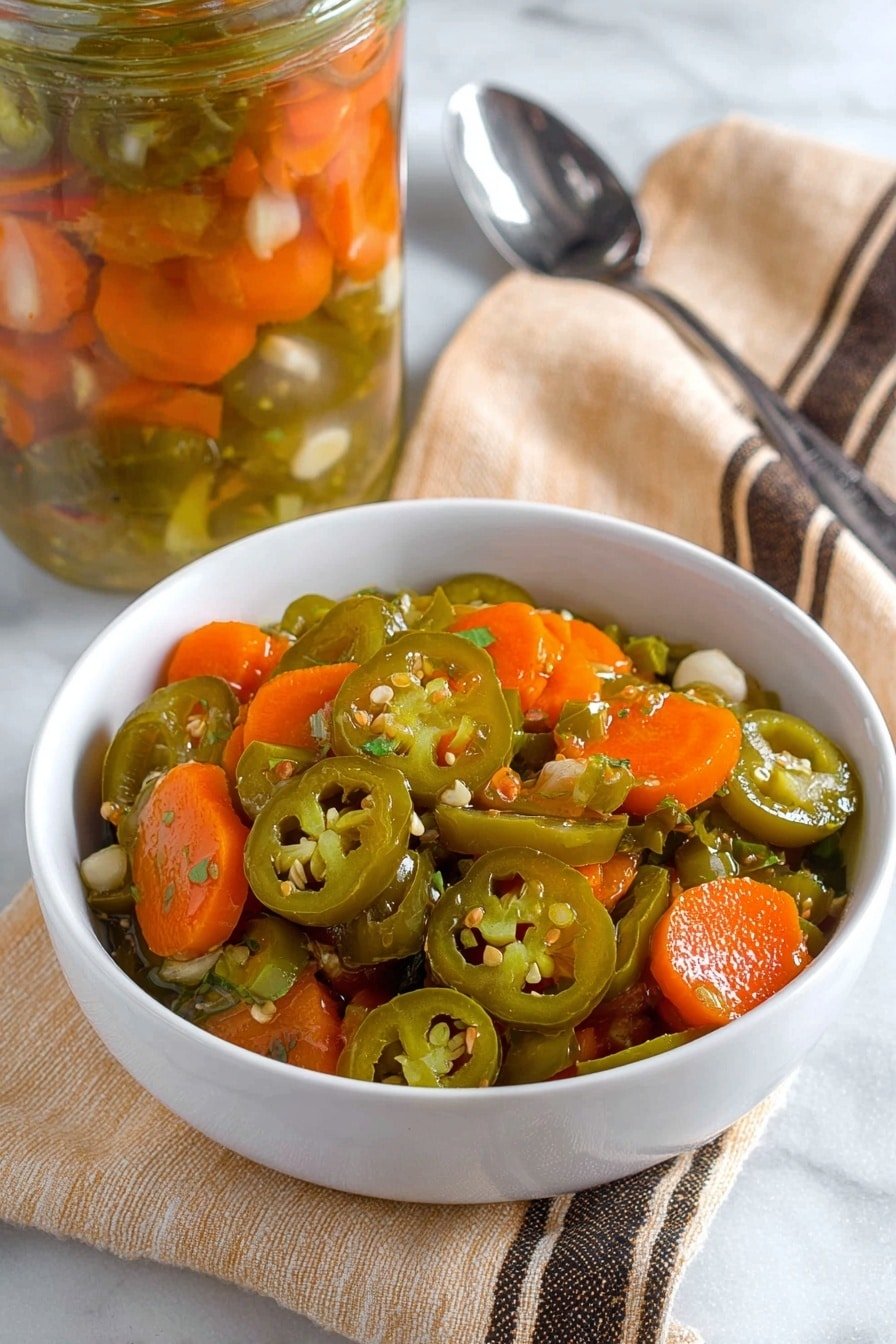 A clear glass jar with a silver metal lid is held by a woman's hand, filled with sliced orange carrots and green jalapeño peppers mixed with white garlic pieces and small black peppercorns, all suspended in a light yellow pickling liquid. The jar shows layers where bright orange carrot slices and green jalapeño rings alternate randomly inside, creating a colorful and textured mix. The background is a white marbled texture with soft pale colors. Photo taken with an iphone --ar 2:3 --v 7