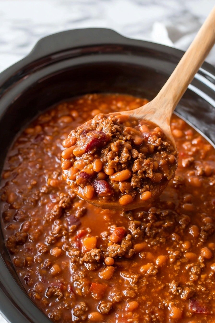 A close-up view of a thick stew inside a white bowl, filled with a mixture of small, soft beans and brown, cooked ground meat chunks in a glossy, reddish-brown sauce. A wooden spoon is lifting a scoop of the stew, showing textured layers of beans and meat with bits of diced vegetables, all covered in a shiny, smooth sauce. The bowl sits on a surface with a white marbled texture. Photo taken with an iphone --ar 2:3 --v 7