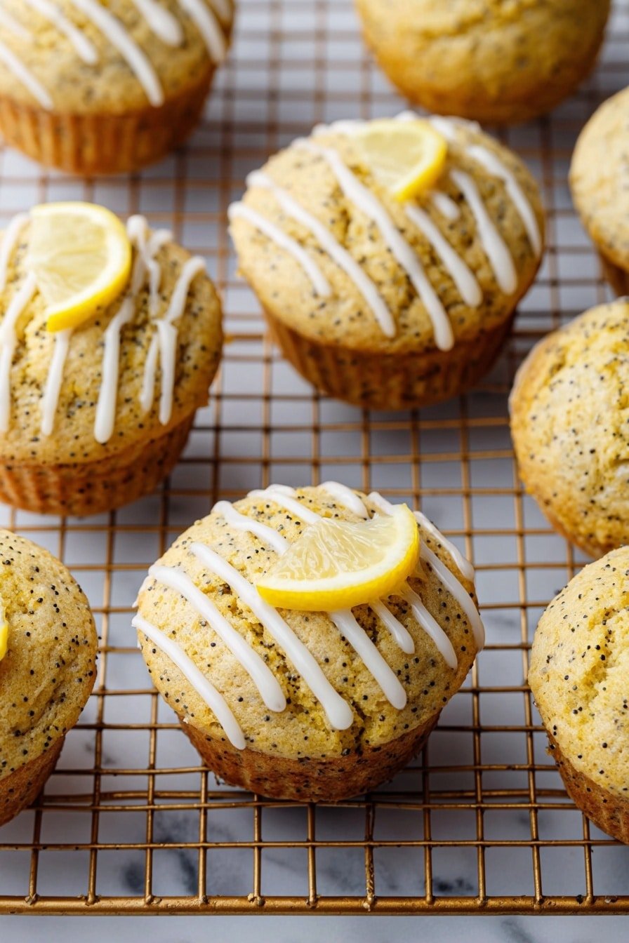 The image shows a group of golden brown lemon poppy seed muffins with small dark poppy seeds throughout. Each muffin is topped with thin white icing drizzled in diagonal lines. One muffin has a small lemon wedge placed on top, adding a bright yellow contrast. The muffins are on a metal cooling rack, and the photo is taken against a white marbled texture that is barely visible. The muffins look soft with lightly cracked tops. photo taken with an iphone --ar 2:3 --v 7