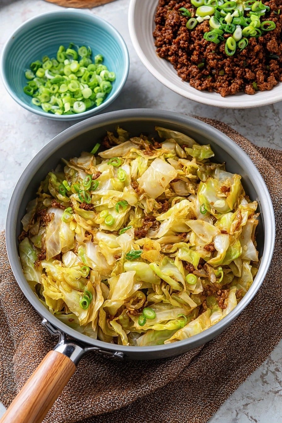 A gray pan with a wooden handle sits on a white marbled surface, filled with cooked cabbage and green onion pieces. The cabbage is light yellow with some wilted parts and bits of green onion scattered throughout. Behind the pan, there is a white bowl with a dish of dark brown cooked minced meat topped with chopped green onions. To the left side, there is a small light blue bowl filled with chopped green onions. A textured green cloth is placed under the pan's handle. The photo taken with an iphone --ar 2:3 --v 7