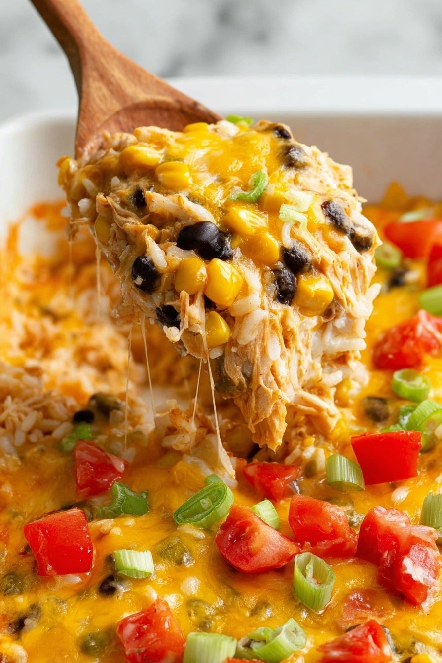 A white spoon lifts a scoop of creamy layered casserole showing three main layers: a top thick melted cheese layer in golden yellow with slightly browned spots, a middle rice layer mixed with black beans, yellow corn, diced green peppers, and shredded chicken, and a bottom layer of more melted cheese. The casserole dish beneath is filled with more melted cheese topped with chopped bright red tomatoes and green onion pieces. The background is a white marbled surface. photo taken with an iphone --ar 2:3 --v 7